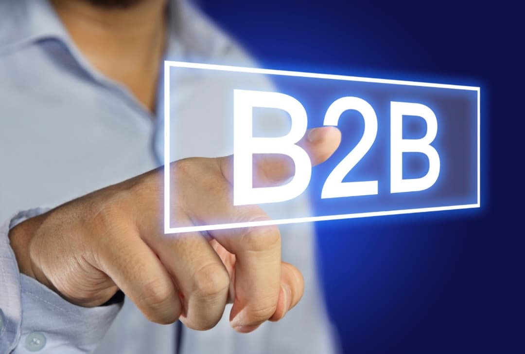 Business professional pressing a virtual B2B button on a digital touchscreen interface